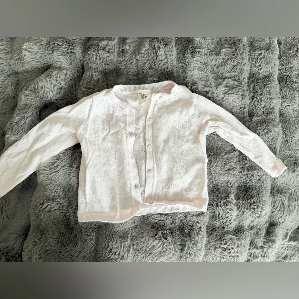 Light pink cardigan size 9-12M has a faint stain